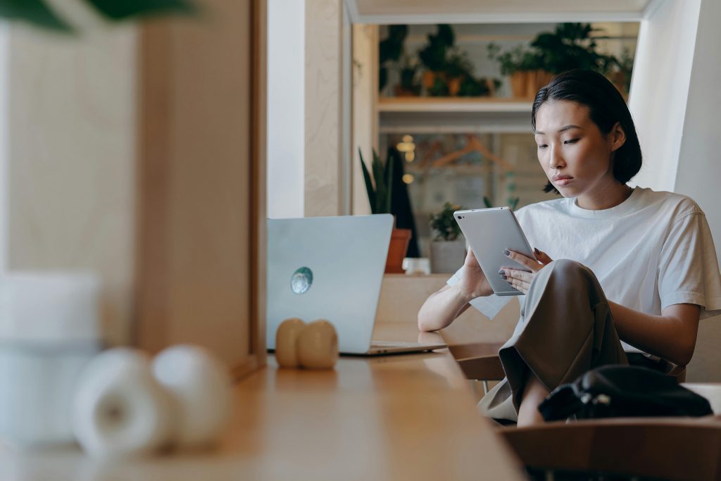 Image of a woman holding an Ipad. This is the introduction to my article "How to Leverage the Halo Effect in Branding and Marketing"