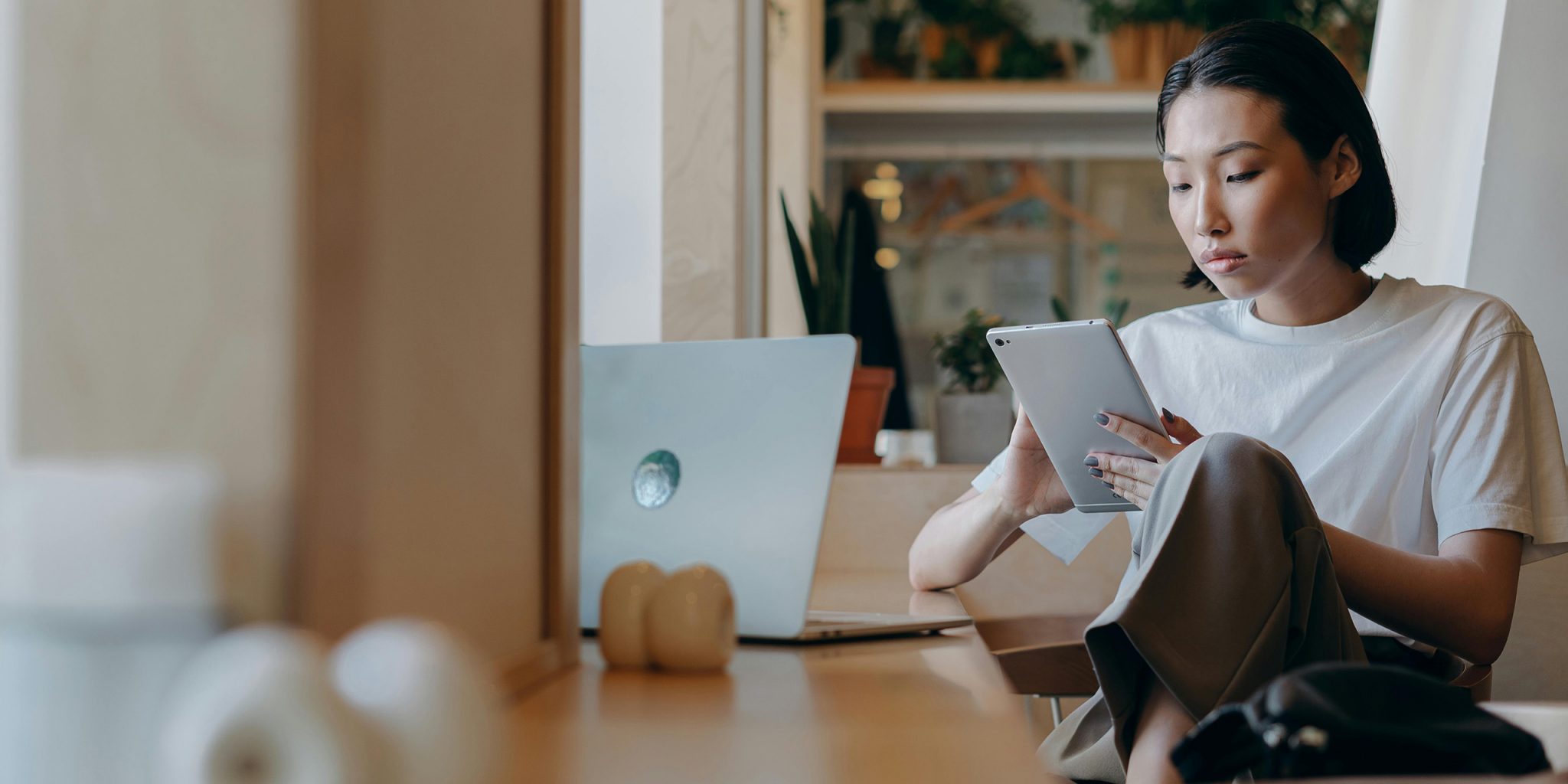 Image of a woman holding an Ipad. This is the introduction to my article "How to Leverage the Halo Effect in Branding and Marketing"