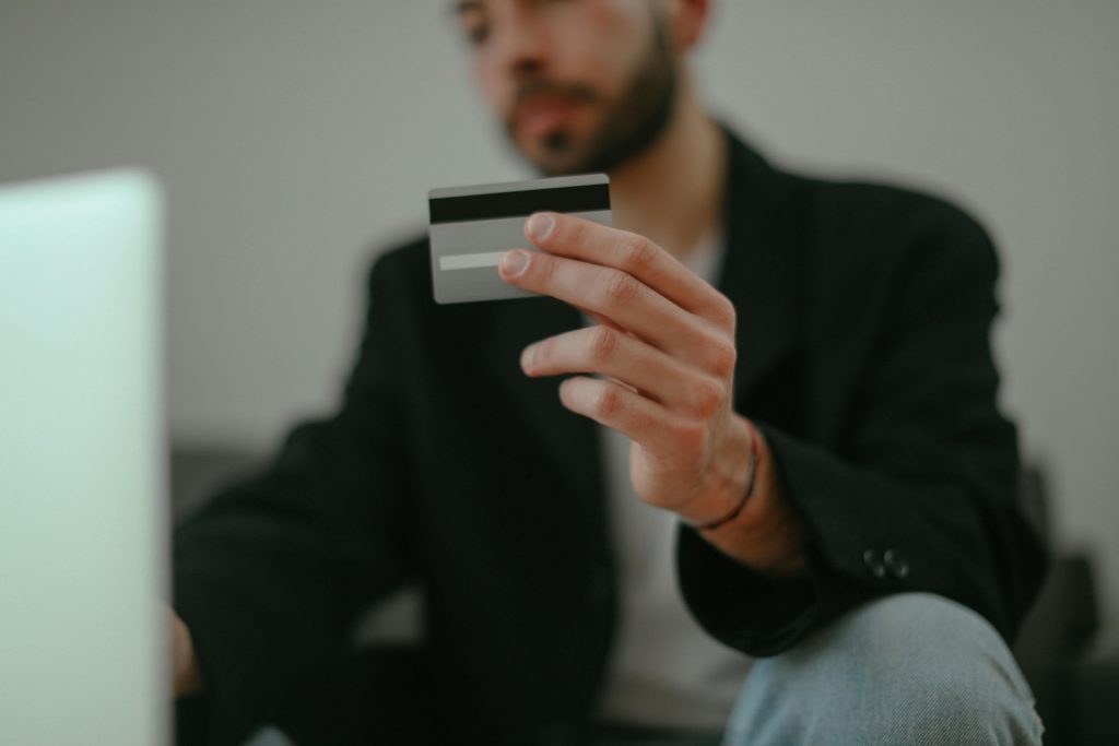 A man holding a credit card. This is the introduction to an article about 10 cognitive biases brands can leverage