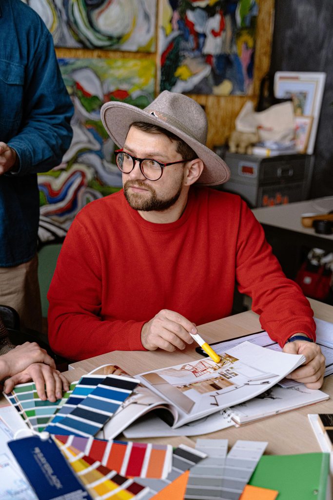 A man selecting brand colours as an intro to the article "10 Pitfalls When Choosing Brand Colours and How to Avoid Them"